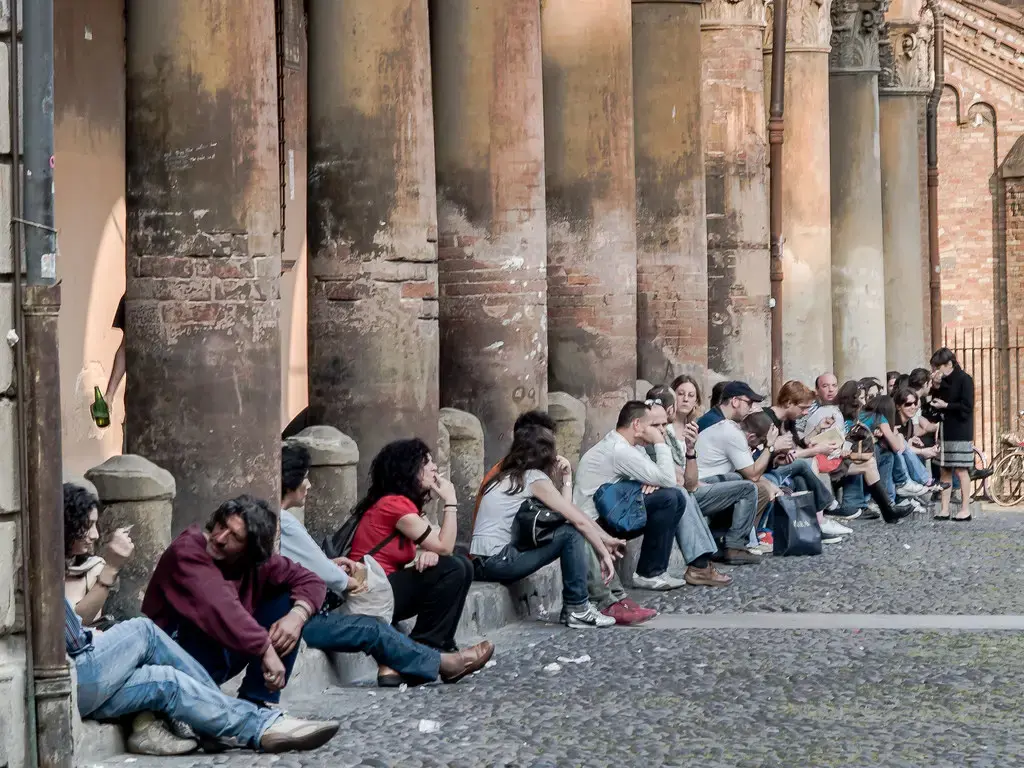 University students sitting together outside a colonnade